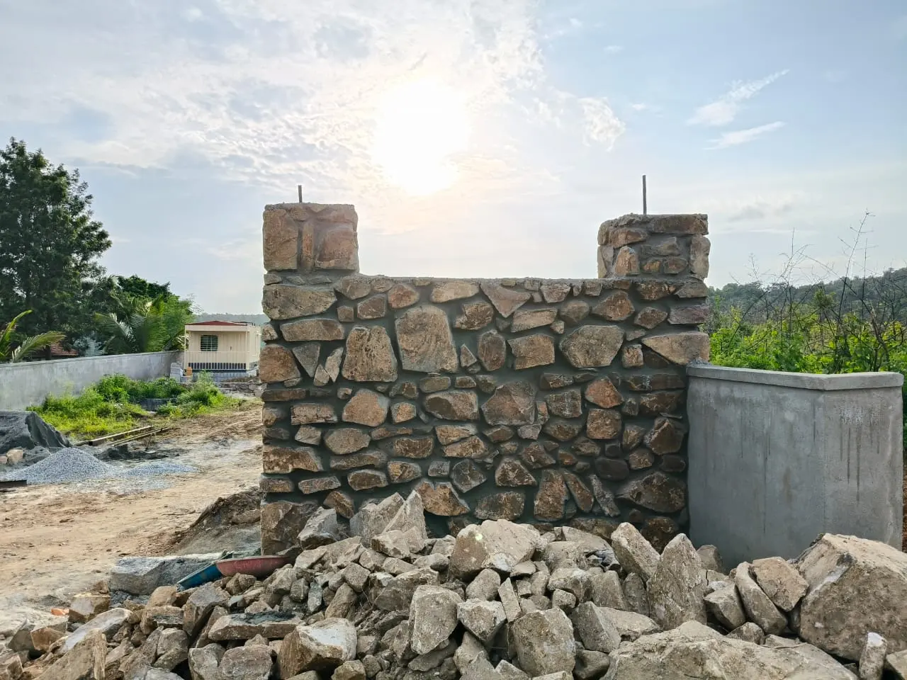 Stone pillar and compound wall built by Dhanalakshmi Construction